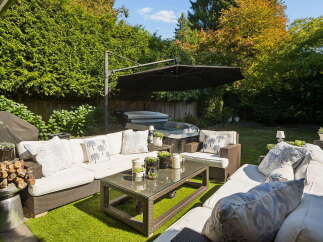 Enjoy ultimate relaxation in this stunning backyard oasis, complete with a luxurious hot tub and ample seating for entertaining.