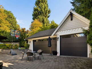 Enjoy outdoor recreation with a basketball hoop and a patio set in the backyard, perfect for family fun.
