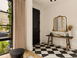 Step into this elegant entryway featuring a striking black and white checkered tile floor that adds a bold, graphic statement.