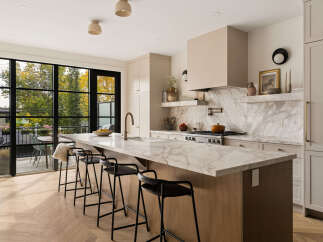 Experience luxury in this modern kitchen featuring a stunning marble island with ample seating, perfect for entertaining.