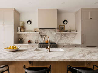 Experience luxury in this stunning kitchen, featuring a sleek marble island and countertops that beautifully complement the custom cabinetry.