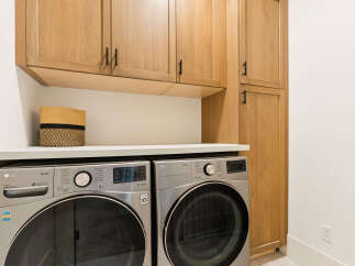 Discover a modern and functional laundry space featuring sleek LG ThinQ washers and dryers, perfect for handling all your laundry needs.