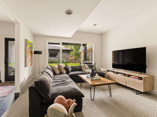 Experience modern comfort in this inviting living room, featuring a spacious sectional sofa perfect for relaxation and entertainment.