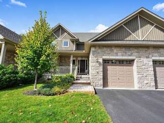 Discover this stunning home featuring a charming stone facade and a welcoming covered porch.
