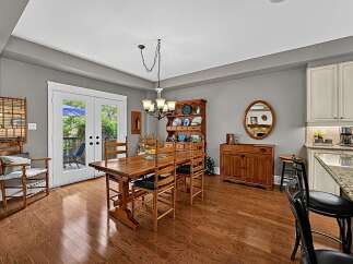 This charming dining area features a beautiful wooden dining table with matching chairs, perfect for family meals.