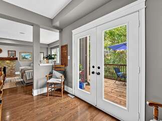 Step outside to a beautiful wooden deck, perfect for enjoying the outdoors.