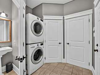 Discover the convenience of this compact laundry space, featuring a stacked LG washer and dryer.