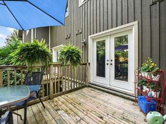 Enjoy outdoor living on this charming wooden deck, perfect for relaxing or entertaining.