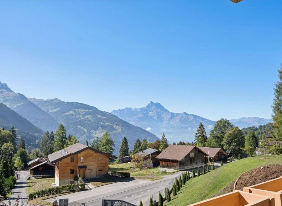 Experience serene mountain living in this charming wooden chalet nestled amidst breathtaking alpine scenery.