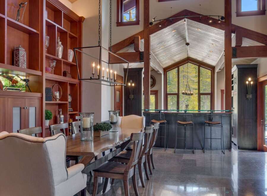 Experience luxurious mountain living in this stunning dining room, featuring a grand live-edge dining table perfect for hosting.