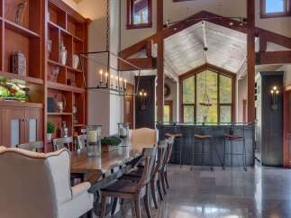 Experience luxurious mountain living in this stunning dining room, featuring a grand live-edge dining table perfect for hosting.