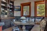 Enjoy cozy meals in this charming breakfast nook featuring a round glass-top table and comfortable built-in seating.