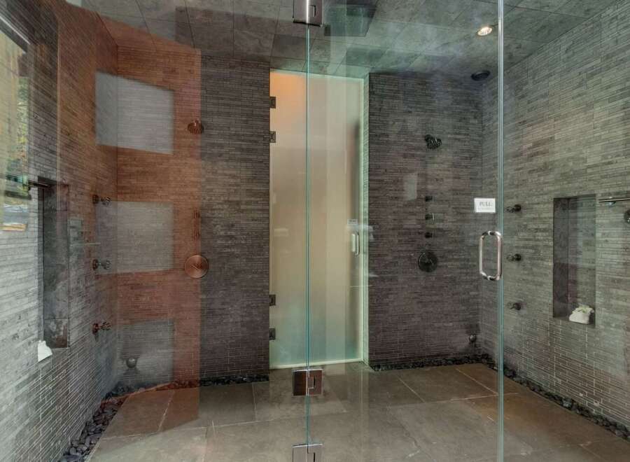 Experience ultimate relaxation in this luxurious spa-like shower featuring multiple shower heads and a sleek glass enclosure.