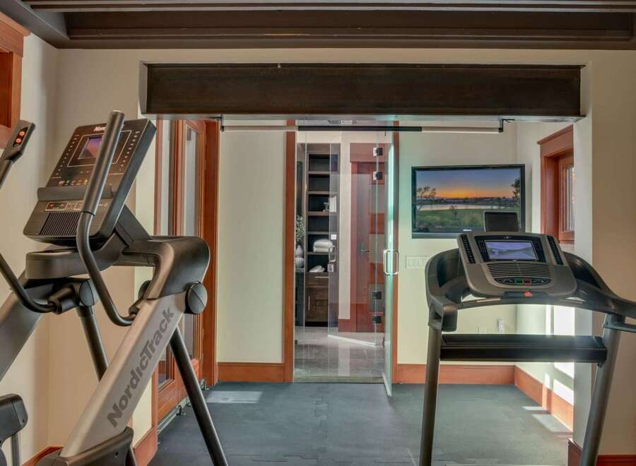 Elevate your fitness routine in this dedicated home gym, featuring a NordicTrack elliptical and a treadmill.