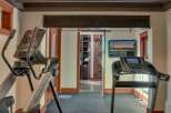 Elevate your fitness routine in this dedicated home gym, featuring a NordicTrack elliptical and a treadmill.