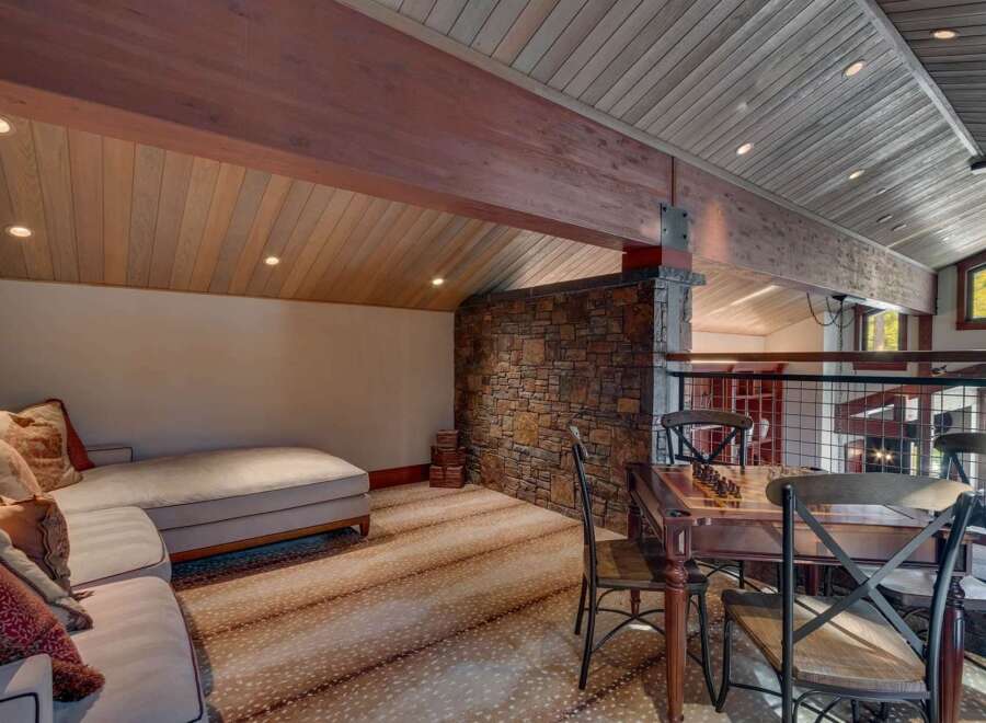 Experience rustic charm in this unique living space, featuring a cozy chaise lounge perfect for relaxation.
