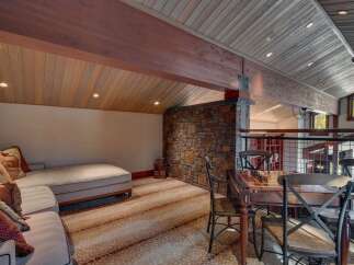 Experience rustic charm in this unique living space, featuring a cozy chaise lounge perfect for relaxation.