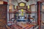 Experience luxury mountain living in this stunning home featuring a dedicated game room with a chess table, perfect for evening entertainment.