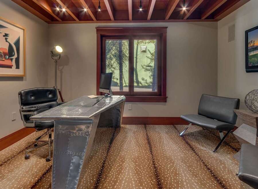 Step into this stylish home office featuring a unique aviator-style desk and a comfortable black leather executive chair.