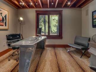 Step into this stylish home office featuring a unique aviator-style desk and a comfortable black leather executive chair.