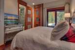Experience ultimate comfort in this beautifully appointed bedroom, featuring a plush bed and a modern dresser with an integrated TV.