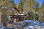 Nestled amidst towering pines, this charming mountain home offers a serene retreat.