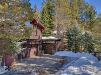 Nestled amidst towering pines, this charming mountain home offers a serene retreat.