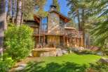 Experience luxury mountain living in this stunning home, featuring a grand stone fireplace and expansive decks perfect for entertaining.