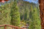 Experience breathtaking mountain views from this stunning property, nestled amidst a lush forest with a serene creek flowing below.