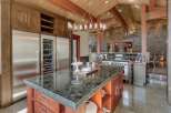 Experience luxury in this expansive gourmet kitchen, featuring a massive granite-topped island perfect for entertaining.