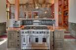 Experience culinary excellence in this stunning chef's kitchen, featuring a professional-grade Viking range and a spacious granite countertop perfect for meal preparation.