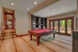 This basement recreation room offers a perfect blend of entertainment and relaxation.