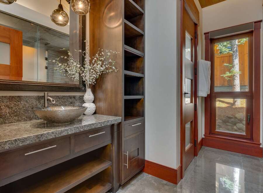 This luxurious bathroom features a stunning granite countertop with a unique vessel sink and a modern faucet.