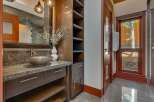 This luxurious bathroom features a stunning granite countertop with a unique vessel sink and a modern faucet.