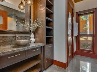 This luxurious bathroom features a stunning granite countertop with a unique vessel sink and a modern faucet.