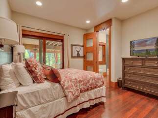 This charming bedroom features a comfortable bed adorned with plush pillows and a decorative duvet, creating a cozy retreat.