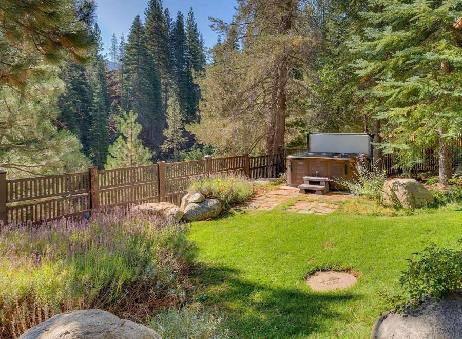 Enjoy ultimate relaxation in this backyard oasis, featuring a luxurious hot tub perfect for unwinding after a long day.