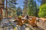 Experience the ultimate outdoor living with this stunning patio featuring a stone fire pit and comfortable Adirondack chairs, perfect for gathering with loved ones.