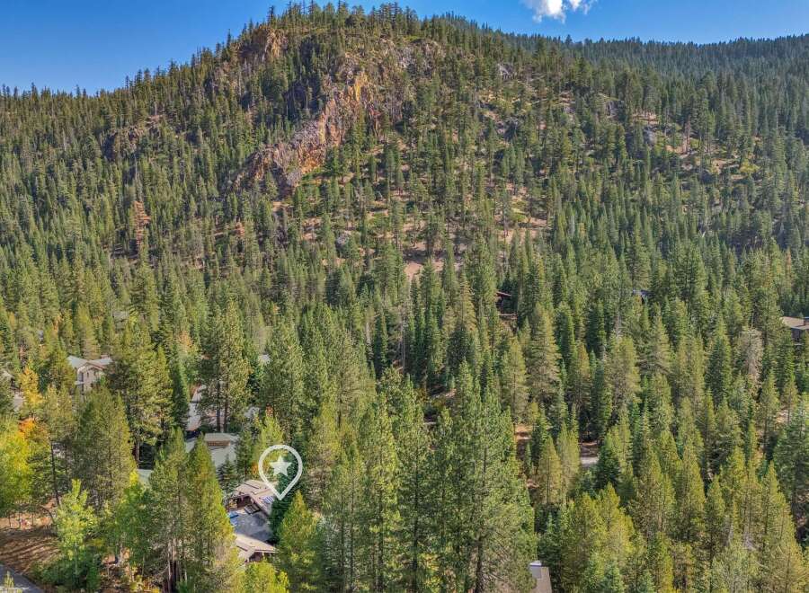 Nestled amidst a dense forest, this property offers a secluded mountain retreat.
