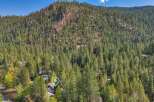 Nestled amidst a dense forest, this property offers a secluded mountain retreat.
