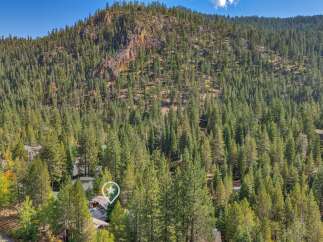Nestled amidst a dense forest, this property offers a secluded mountain retreat.