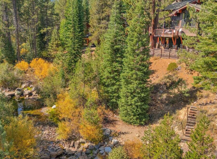 Nestled amidst a vibrant autumn forest, this stunning property offers a unique blend of natural beauty and modern living.