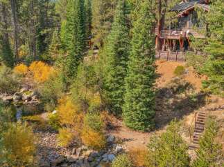 Nestled amidst a vibrant autumn forest, this stunning property offers a unique blend of natural beauty and modern living.