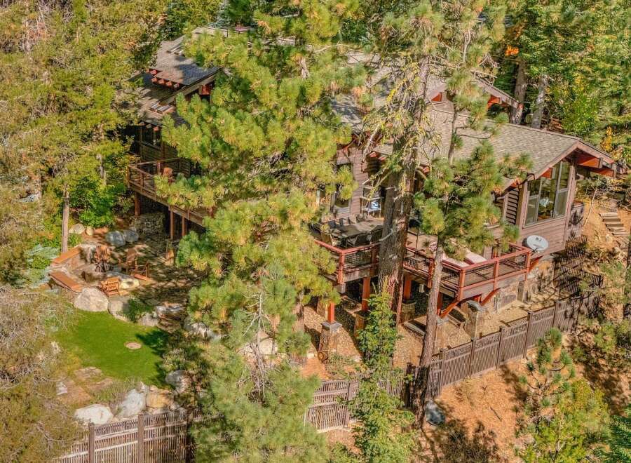 Nestled amongst towering pine trees, this stunning mountain home offers a serene escape.