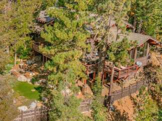 Nestled amongst towering pine trees, this stunning mountain home offers a serene escape.