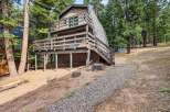 Discover this charming A-frame home nestled among tall pine trees, offering a unique architectural style and a serene natural setting.