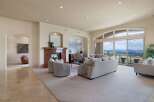 Experience luxurious living in this spacious great room, featuring a stunning marble fireplace and expansive windows that showcase breathtaking panoramic views.