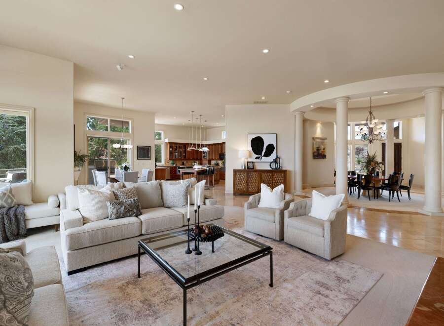 Experience luxurious living in this expansive open-concept home, featuring a gourmet kitchen with rich wood cabinetry and a large island, perfect for entertaining.