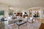 Experience luxurious living in this expansive open-concept home, featuring a gourmet kitchen with rich wood cabinetry and a large island, perfect for entertaining.
