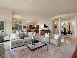 Experience luxurious living in this expansive open-concept home, featuring a gourmet kitchen with rich wood cabinetry and a large island, perfect for entertaining.